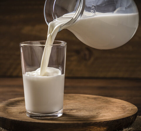 Pouring milk into a drinking glass