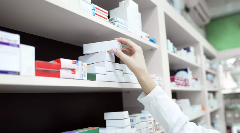 -taking-medicine-box-from-shelf-drug-st__8tngg7q